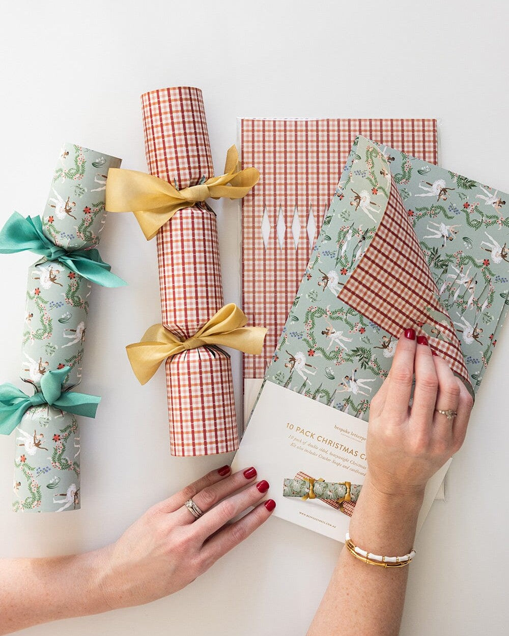 Enchanted cracker kit packaging with finished crackers in red check and green floral print