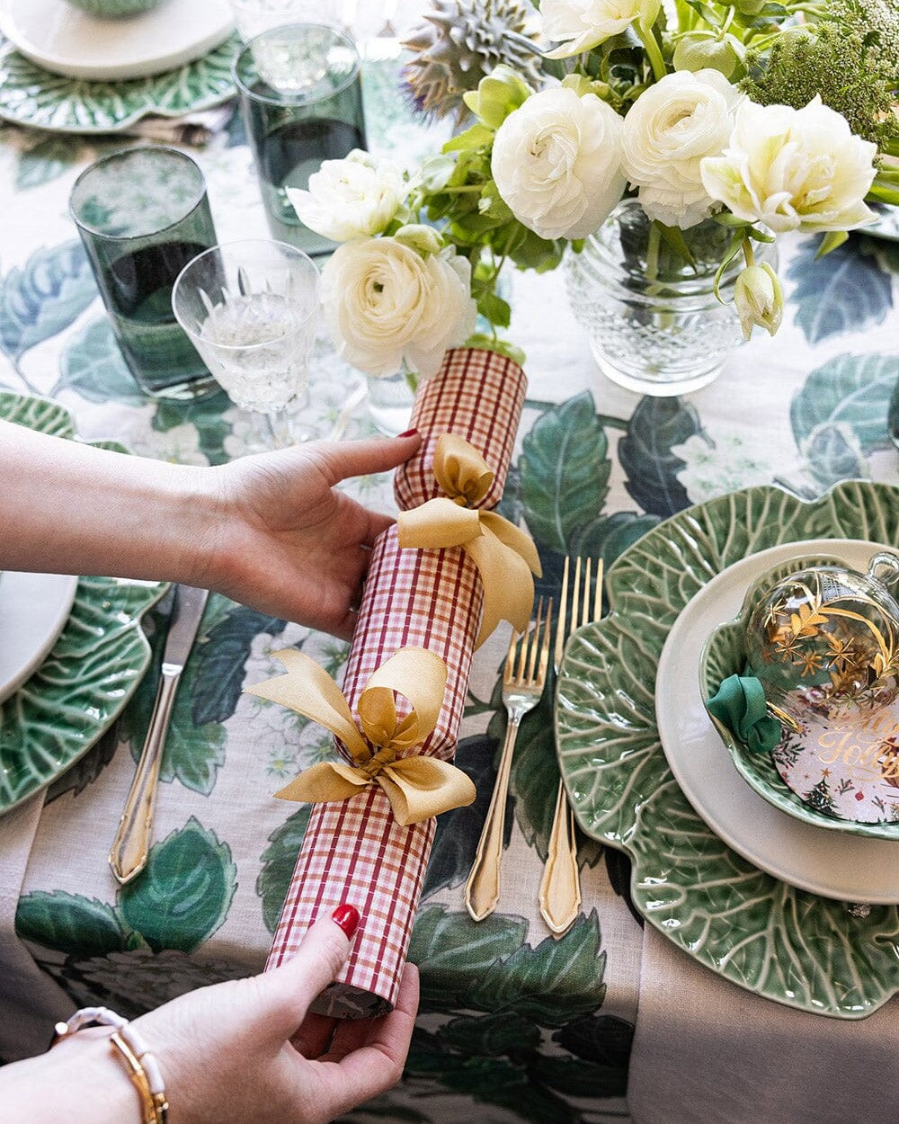 Enchanted Christmas cracker placed on a festive dinner table setting