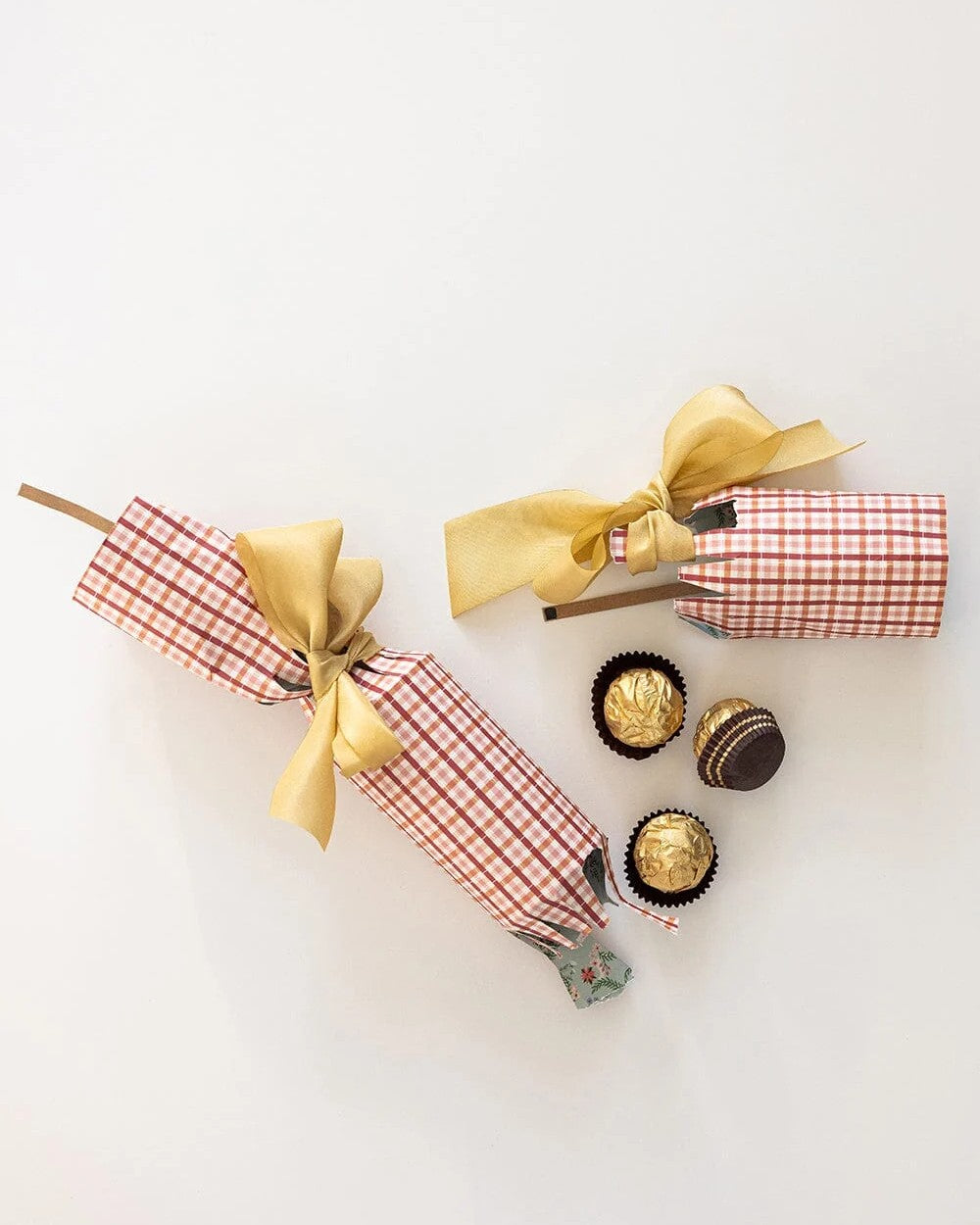Enchanted Christmas crackers filled with chocolates and tied with gold ribbon