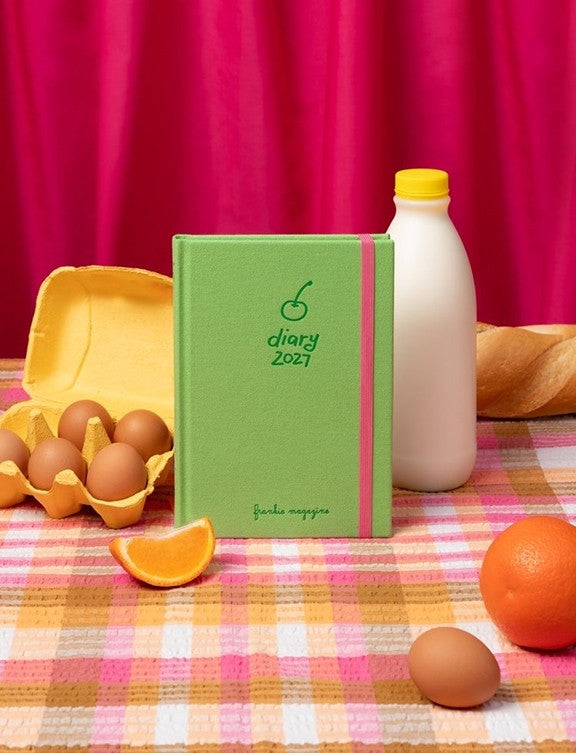 2027 Frankie Diary styled on a gingham tablecloth with eggs, milk and oranges