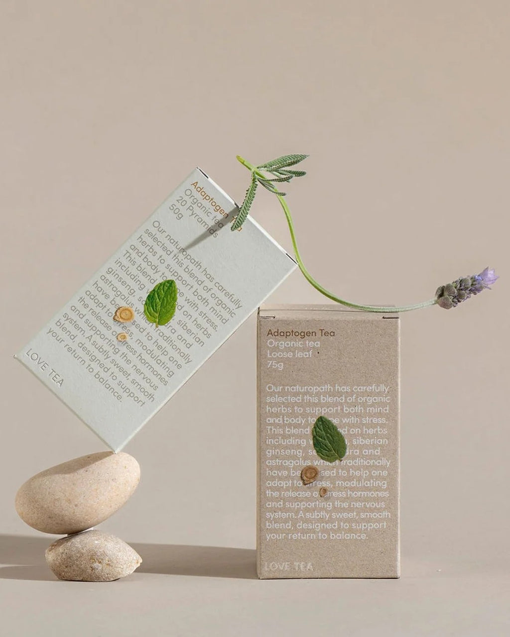 Love Tea Adaptogen Tea loose leaf box styled with stones and lavender